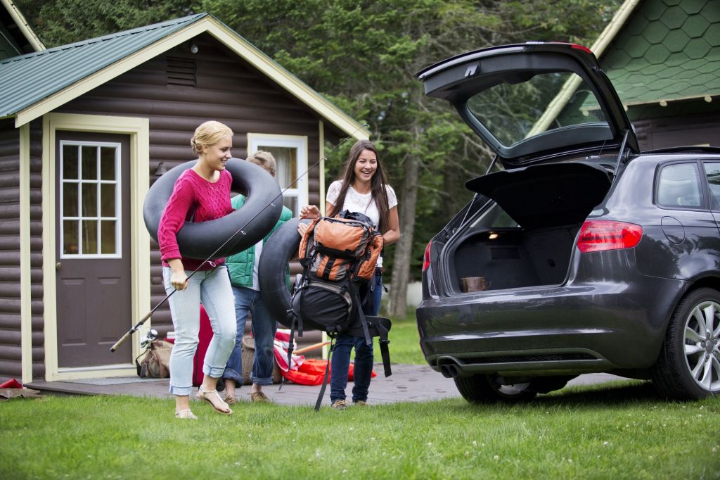 Happy Friends Loading Car For Camping