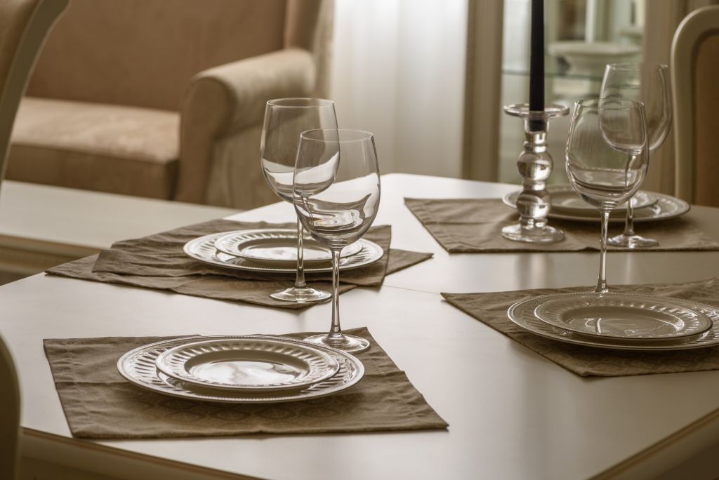 Set of dinner tableware on table in dining room